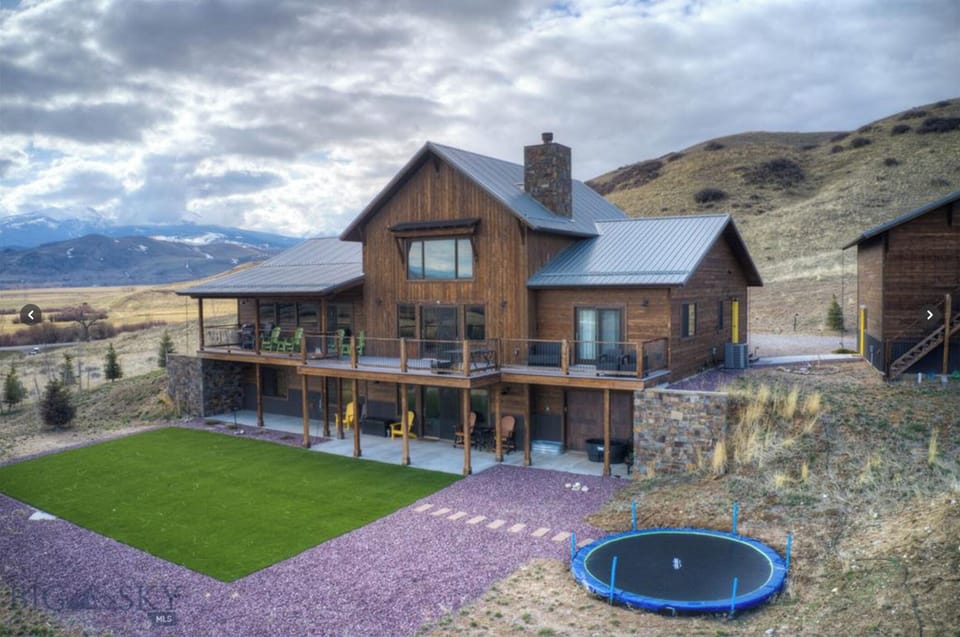 Back of the house with turf play area and trampoline!