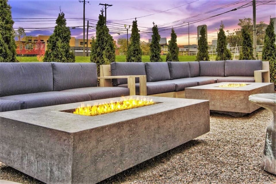 Unwind by the glowing firepits in a stylish outdoor lounge.