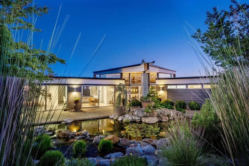 Front view of house from behind the pond and native garden.