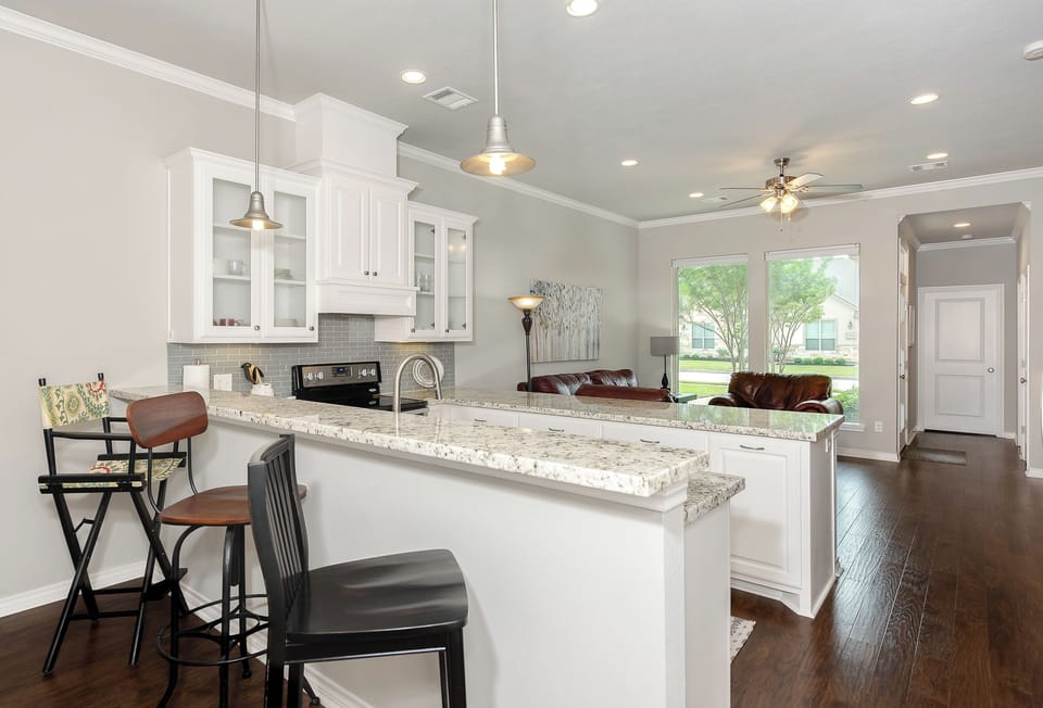 Kitchen with view towards living room and front door