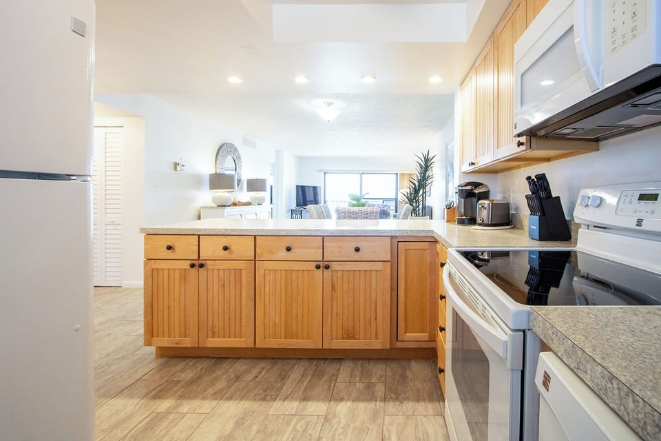 The cozy and functional kitchen is fully equipped with modern appliances and ample counter space.
