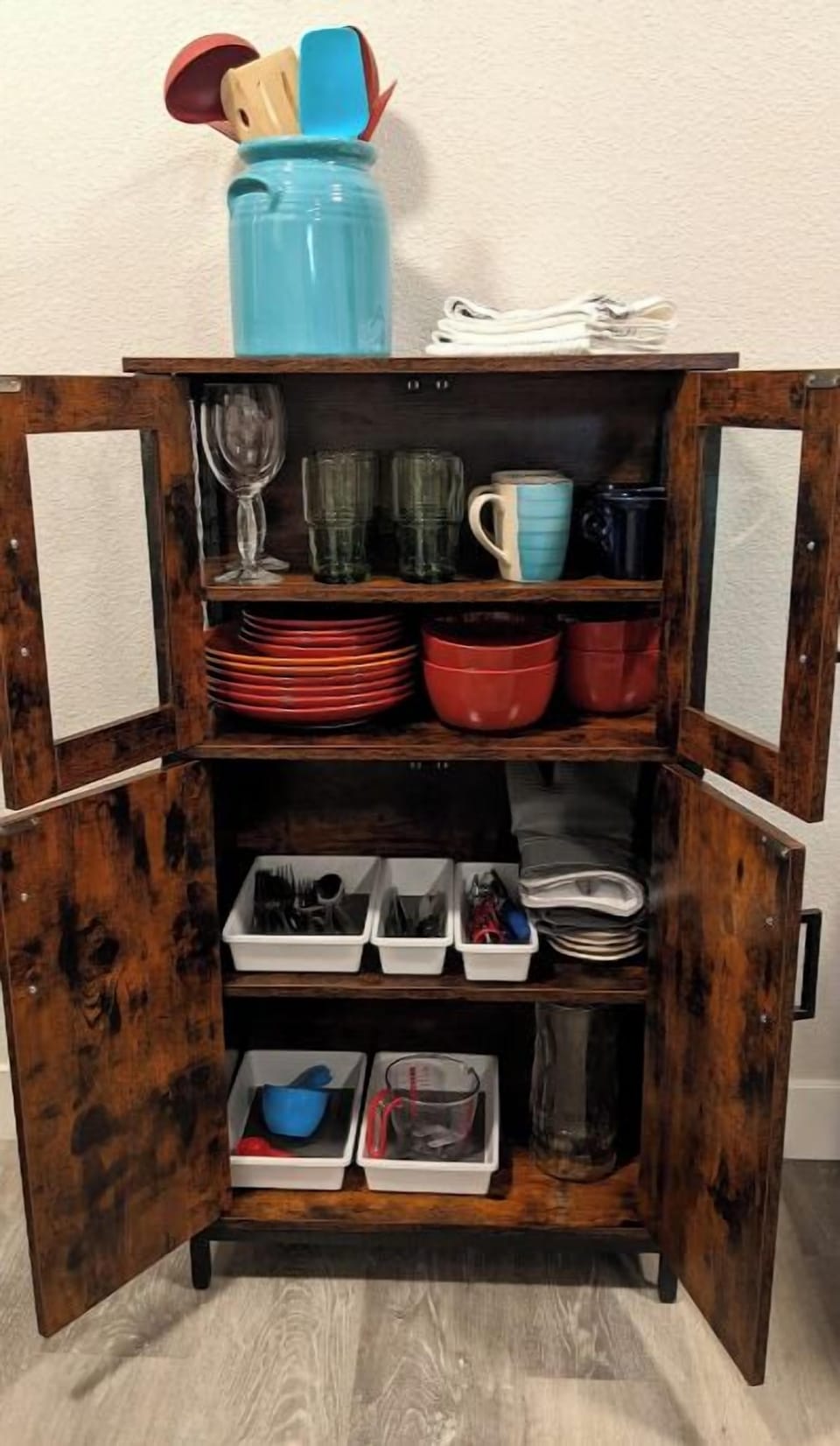 Silverware, measuring spoons, wine opener, can opener, plus pots and pans.