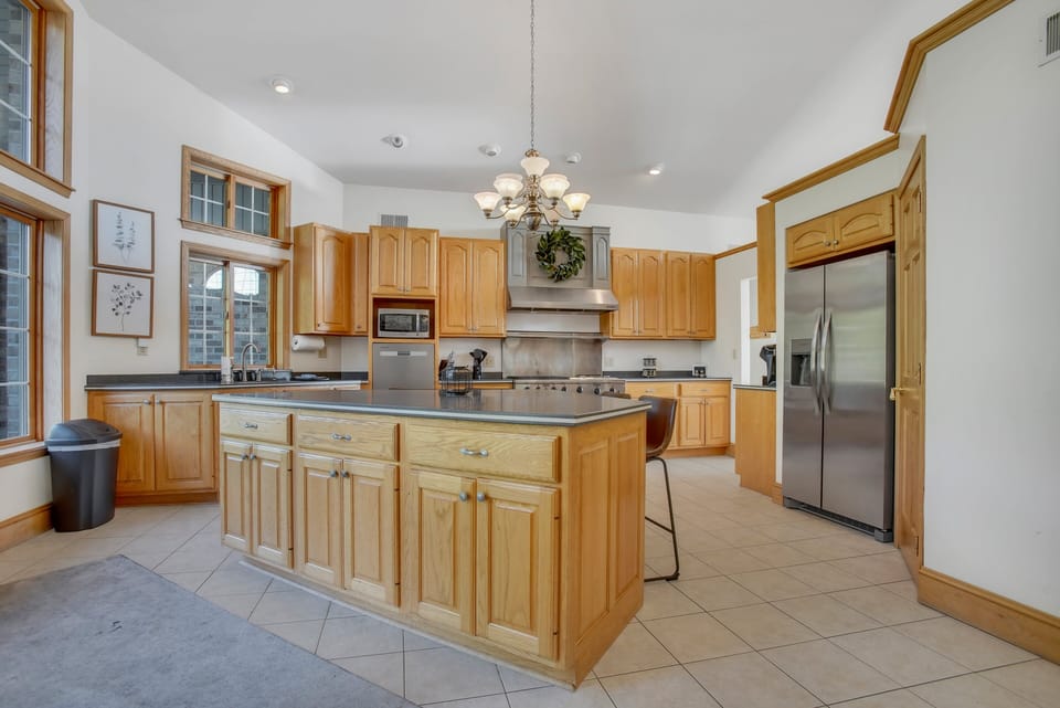 Large island with seating and stainless steel appliances that will wow any chef in the group!
