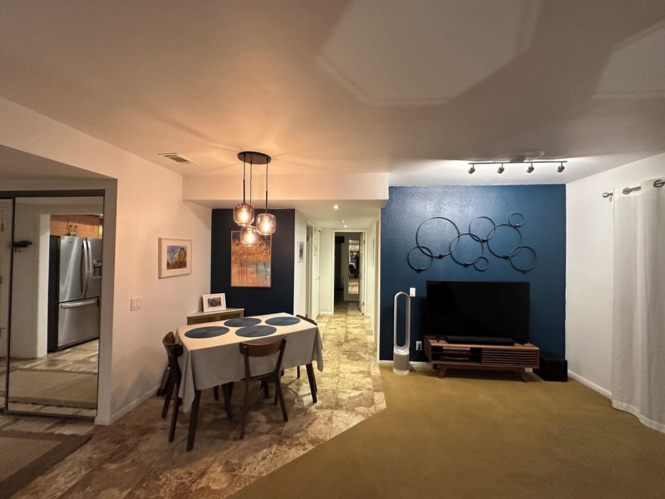 The living room features a sectional with sofa bed & 55-inch TV / surround sound