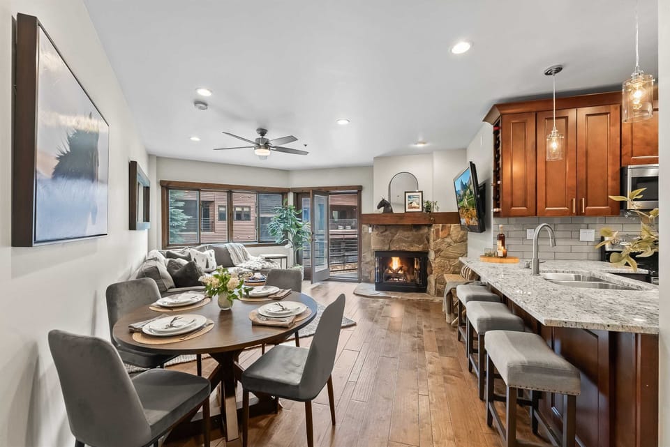 Living room: Couch w/queen pull-out bed, gas fireplace, 65” TV, dining table w/4 chairs