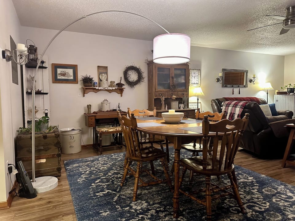 The dining area is open to the kitchen and living room with seating for four.