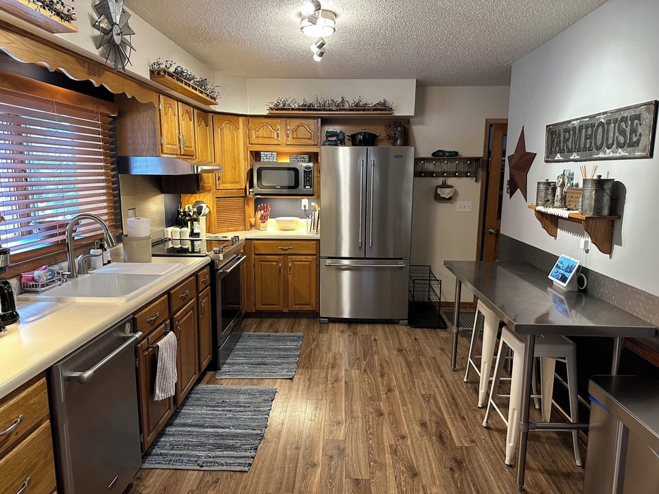 Full kitchen with Maytag stainless steel appliances and breakfast bar seating. 