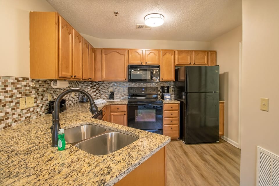 A full kitchen equipped with cookware and dinnerware