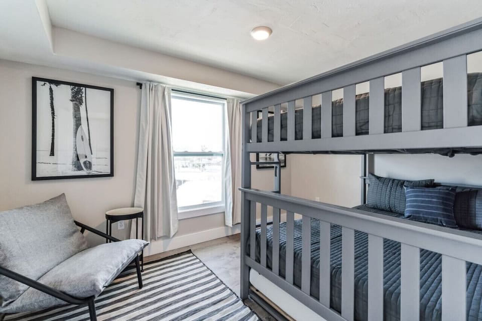 Bunk room with built-in lighting and storage-friendly design.