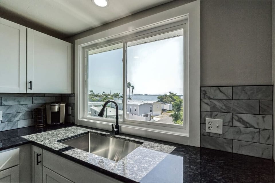 Kitchen window offering a peek at the neighborhood and natural light.