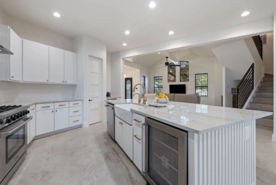 Kitchen features built-in beverage fridge for added convenience. 