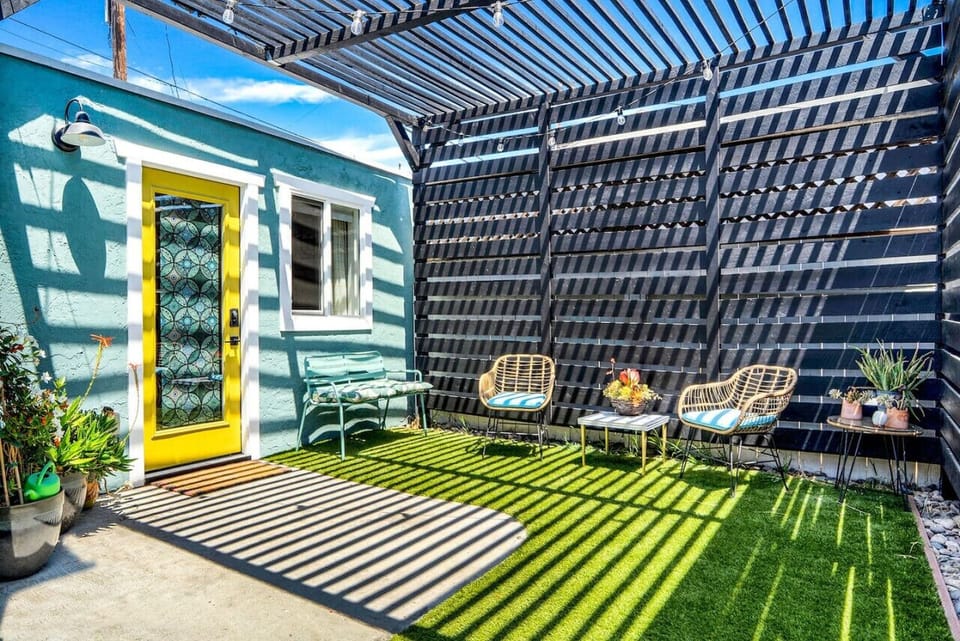 Private outdoor patio w/ string lights & greenery, a relaxing spot to unwind day or night.