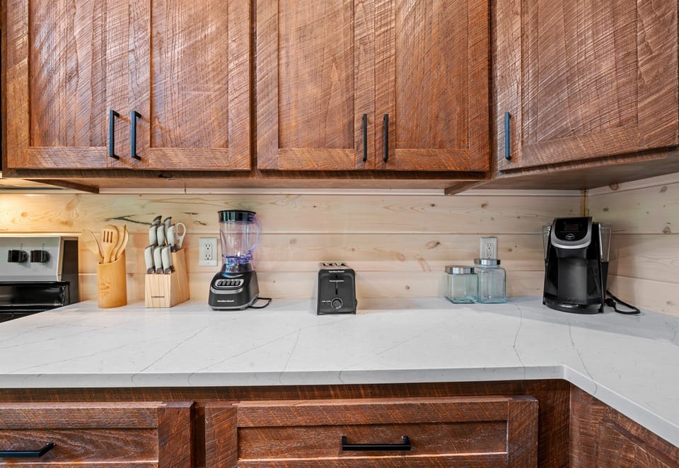 The kitchen counter is fully equipped with essential appliances, ready to assist you in preparing delicious meals.