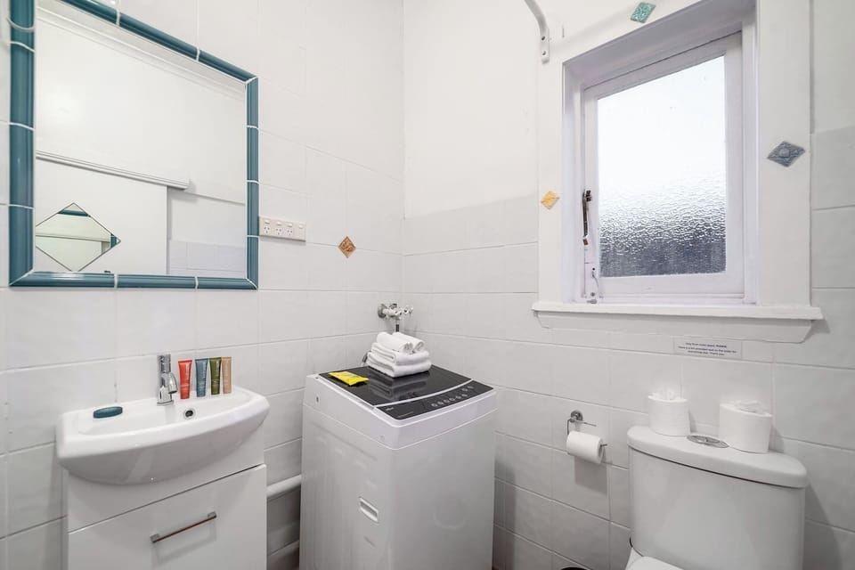 The bathroom includes an in-unit washing machine for your ease.
