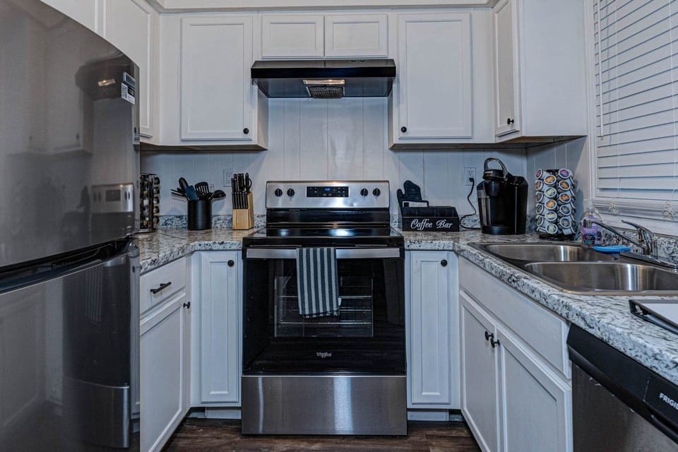Modern Fully Equipped Kitchen with Stainless Steel Appliances and Dishwasher