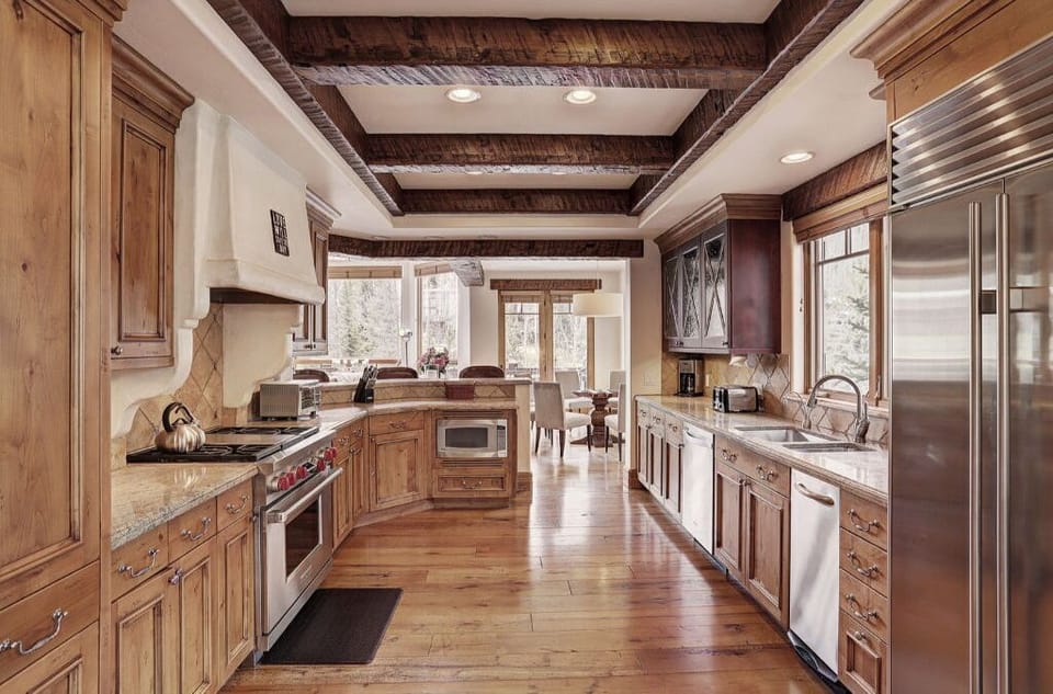 Gourmet kitchen with high-end appliances and wooden cabinetry.