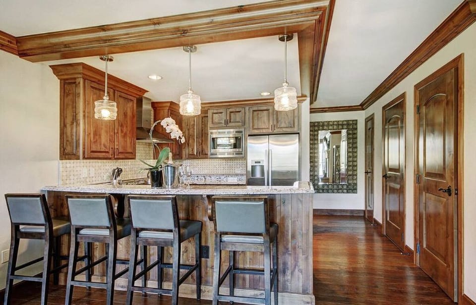 Stylish kitchen with a breakfast bar and wooden accents.