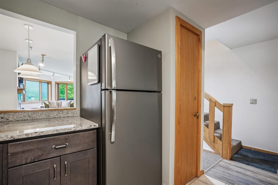 Functional kitchen space with a convenient pass-through window connecting to the dining area.