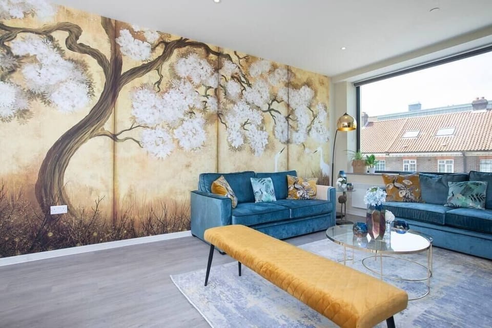 Integrated living, bedroom, and kitchen spaces in an open layout.