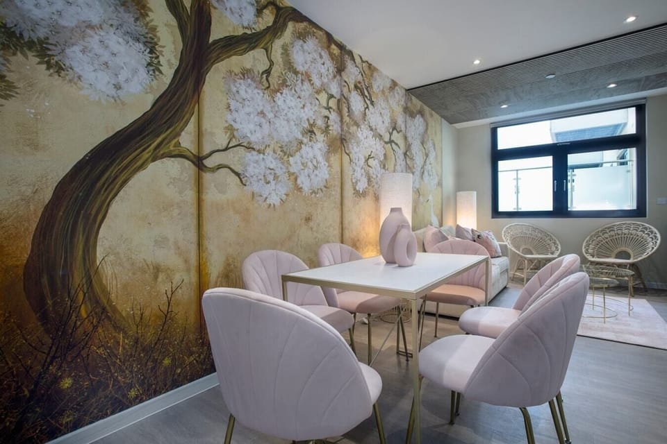 Living room with a sofa, armchairs, dining table, and Smart TV