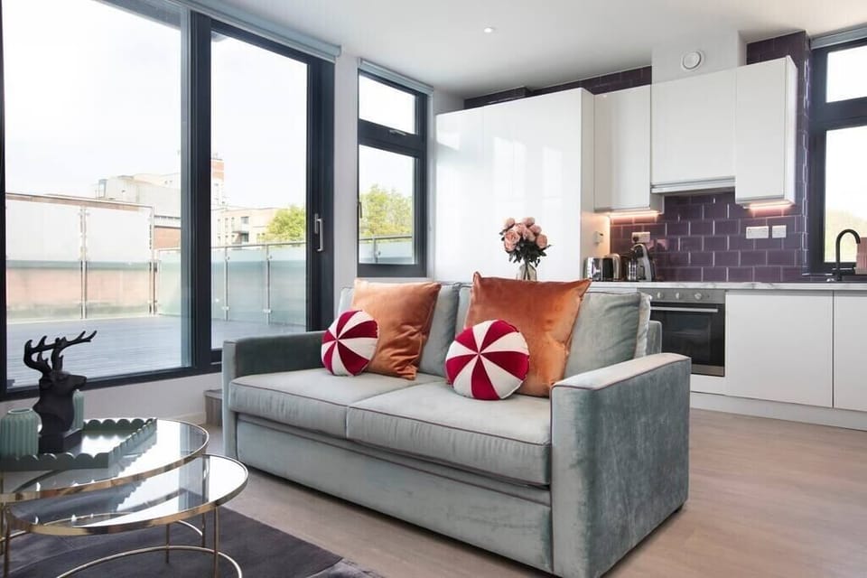 Integrated living, bedroom, and kitchen spaces in an open layout.
