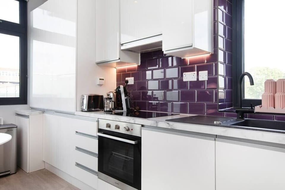 Integrated living, bedroom, and kitchen spaces in an open layout.