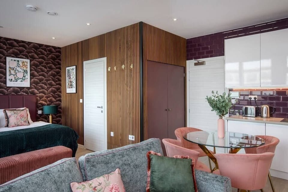 Integrated living, bedroom, and kitchen spaces in an open layout.