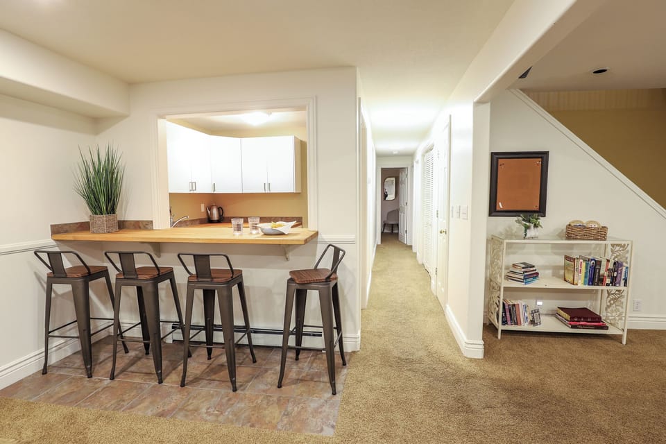 Hallway leading to stocked kitchenette, bathroom and both downstairs bedrooms.