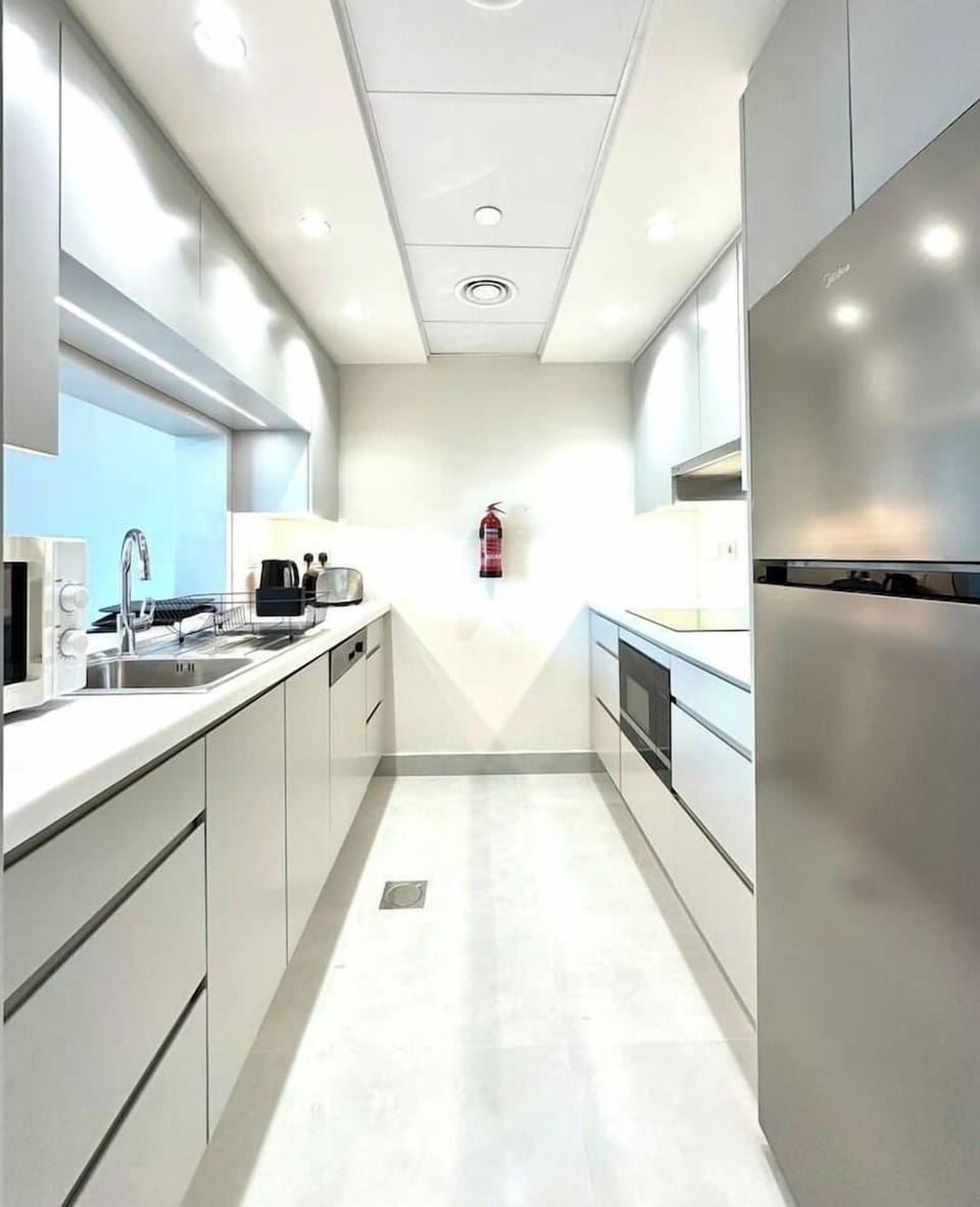 Sleek 1-bedroom holiday home in Burj Views Tower B, Downtown Dubai. Features a modern, fully-equipped kitchen with stainless steel appliances and ample counter space. Perfect vacation rental for short-term in the vibrant heart of Dubai.