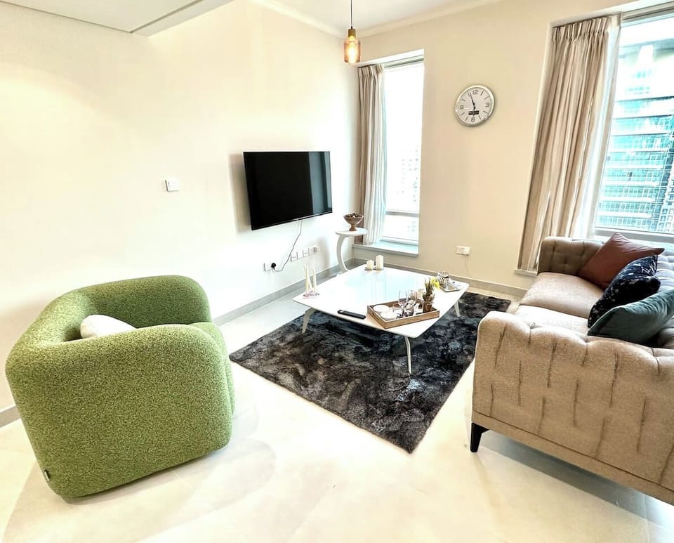 Sophisticated 1-bedroom in Burj Views Tower B, Downtown Dubai. Offers a cozy living area with modern furnishings, flat-screen TV, and large windows. Perfect monthly rental or vacation home in the heart of Dubai's vibrant Downtown district.
