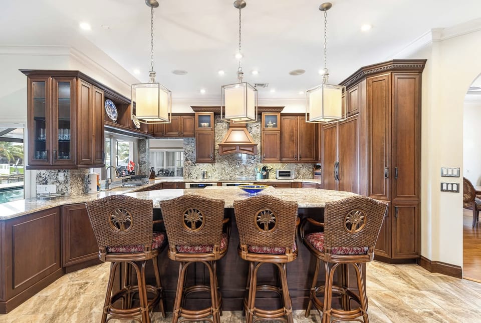 Every gourmet will love this grand and exquisite kitchen with its beautiful custom cabinetry, striking granite countertops, and high-end appliances.