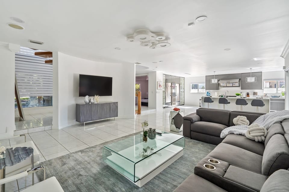 Spacious and open with plenty of seating, this living room is elegant and sophisticated space for you and your companions to sit back, catch up, and watch TV.