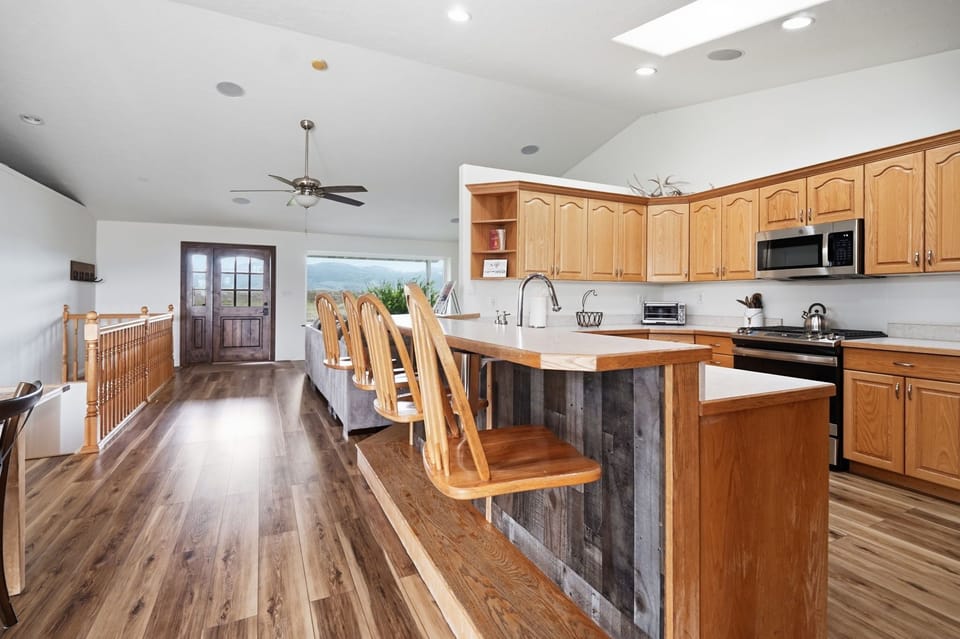 Spacious open kitchen with vaulted ceilings and island seating for four