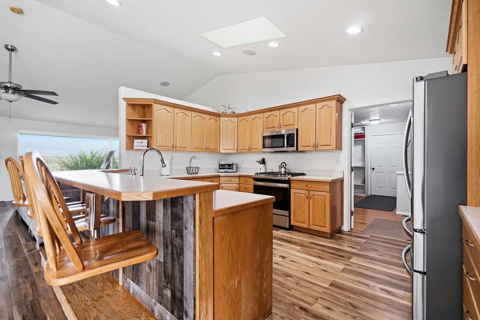 Bright open kitchen with large island seating and stainless steel appliances