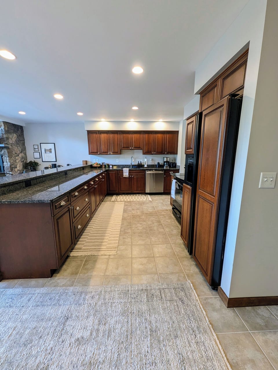 Large kitchen stocked with high end kitchenware and tools for meal preparation.