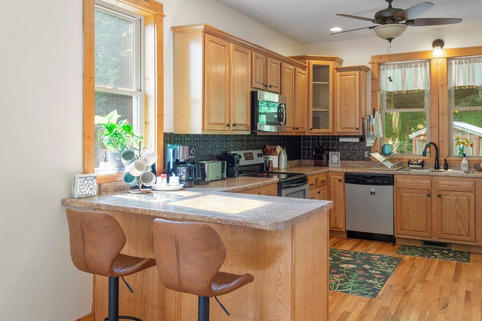 The roomy kitchen is fully stocked with appliances, cookware, and utensils