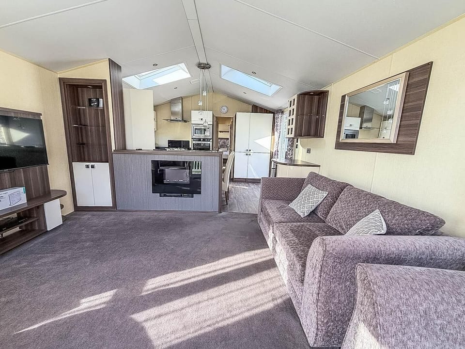If you're planning last minute holidays UK, consider staying at Park Holidays Broadland Sands near Great Yarmouth, Norfolk, where you can enjoy the comfort of a cosy living room in a caravan.