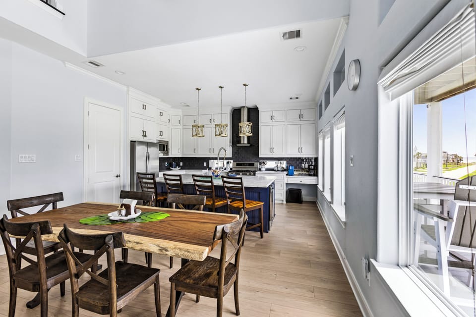 Gather around a stunning wood table, with natural light and stylish decor!