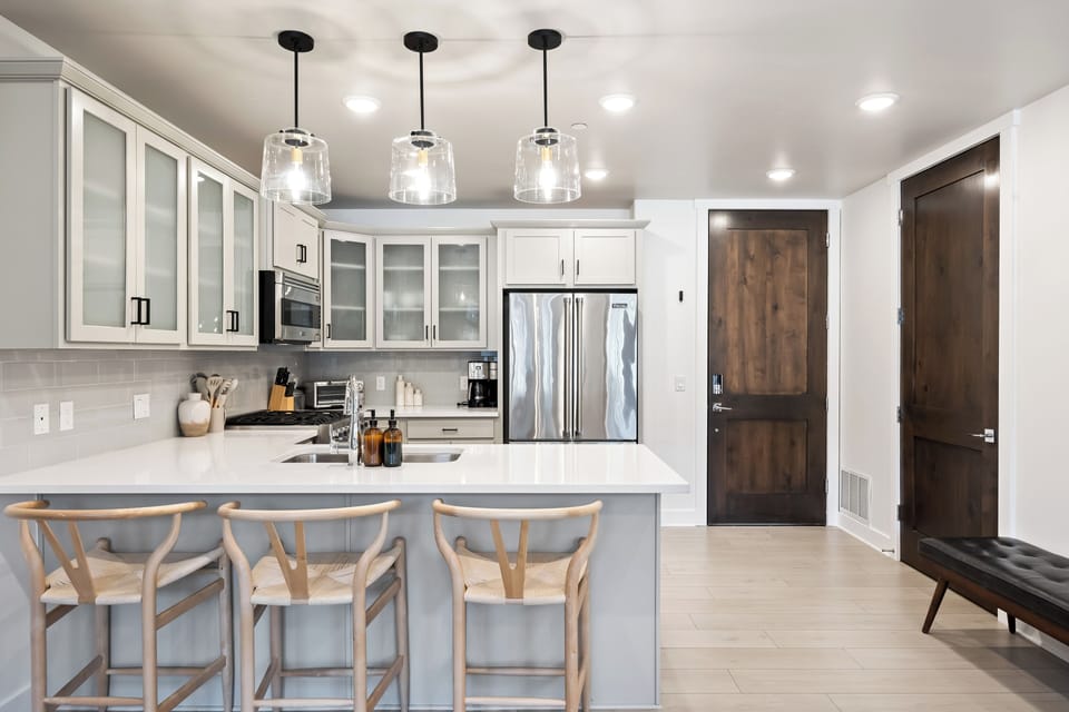 - Fully equipped kitchen with stainless steel appliances  
- Large island with seating for cooking and dining  
- Bright space perfect for family meals and gatherings