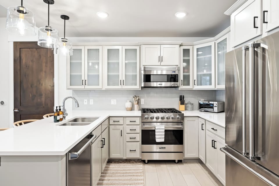 - Gourmet kitchen with Viking appliances and bar seating  
- Bright counters with modern cabinets and lighting  
- Perfect for cooking and hosting mountain retreats