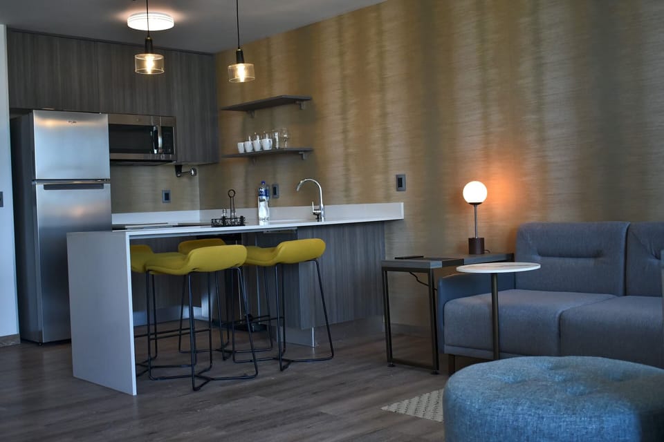 Relax in the lounge beside the modern kitchenette setup.