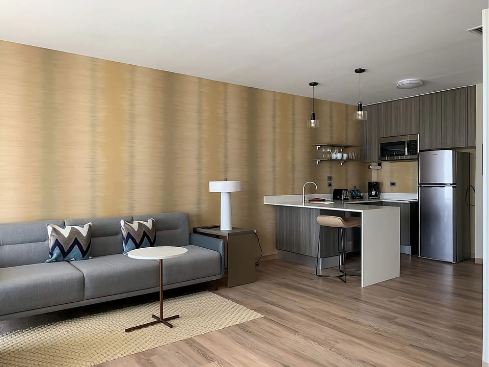 Unwind in a sleek lounge beside your modern kitchenette.