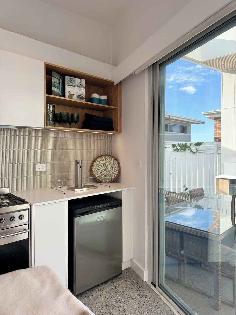 Stocked kitchenette complete with crockery, glasses, coffee maker and utensils.