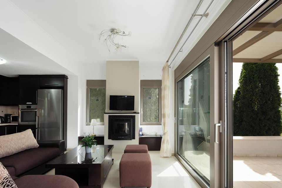 The living room, with its 32” TV, energy-efficient fireplace, and plush sofa, beckons you to unwind and relax.