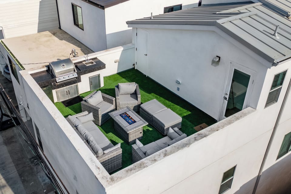 Rooftop with seating and built-in BBQ grill.