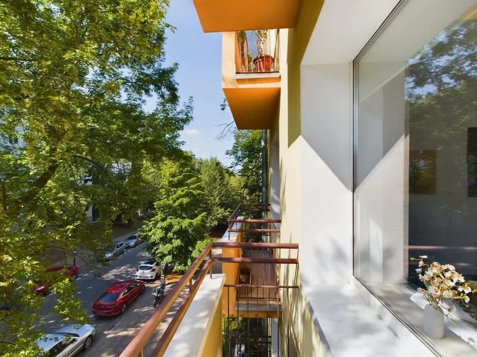 A balcony view overlooking a green courtyard and neighboring balconies. A great place to enjoy fresh air and quiet surroundings.
