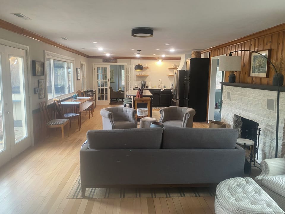 Main room view off of bedroom towards front. Doors to left open lake side porch.