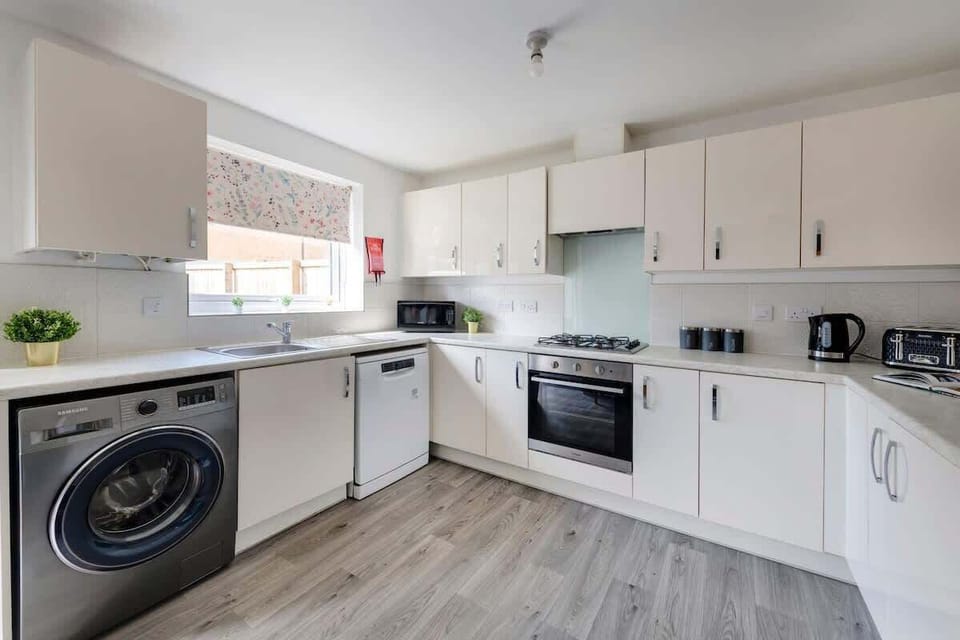 "Cook in style in our beautiful modern kitchen—fully equipped and thoughtfully designed for a sleek, effortless culinary experience."