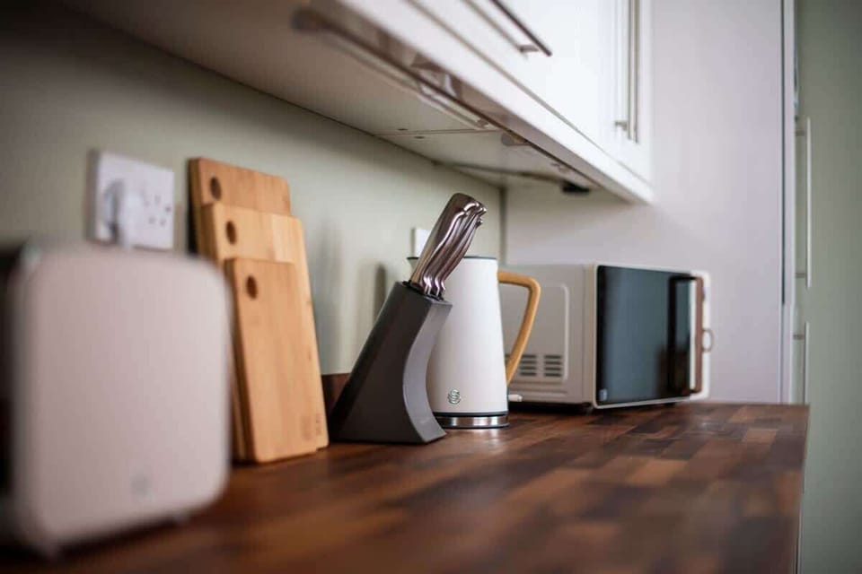 "Cook and dine in this fully equipped, spotless kitchen—featuring modern appliances, ample counter space, and everything you need to prepare your favorite meals."