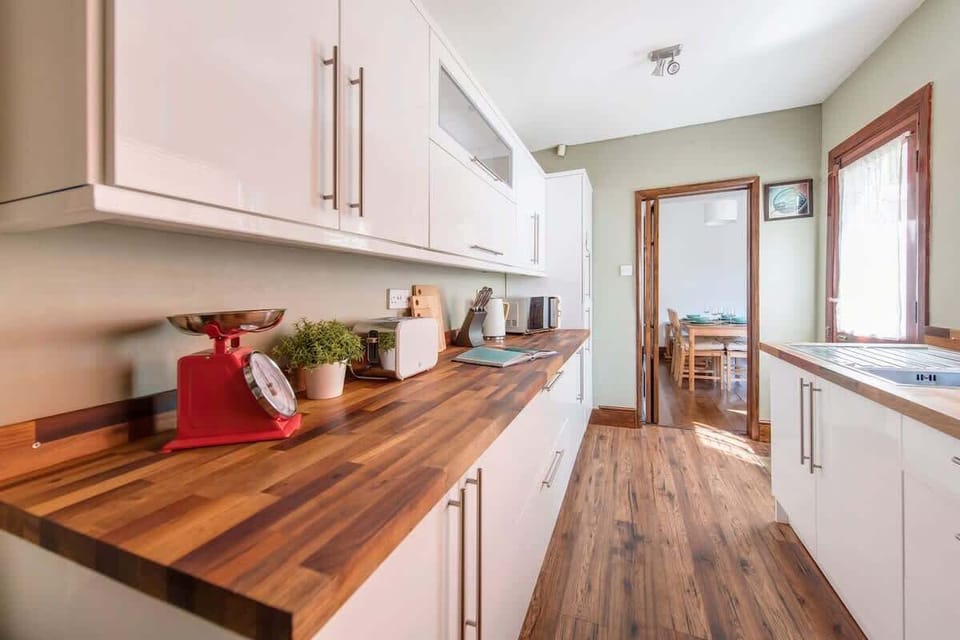 "Cook and dine in this fully equipped, spotless kitchen—featuring modern appliances, ample counter space, and everything you need to prepare your favorite meals."